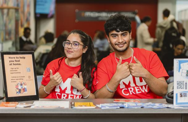 Two MoCrew students giving a thumbs up and smiling