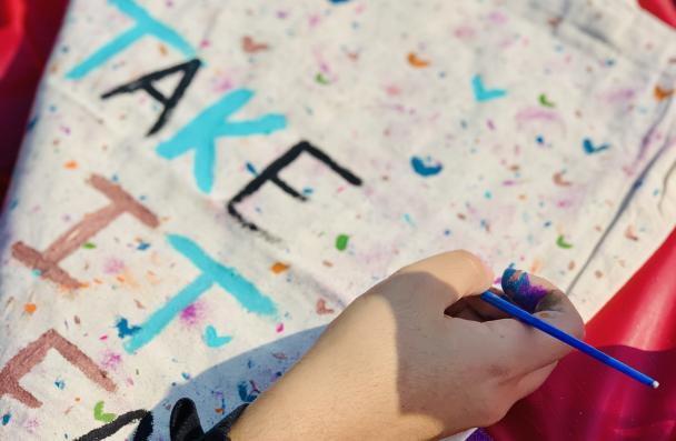 hand painting a tote bag