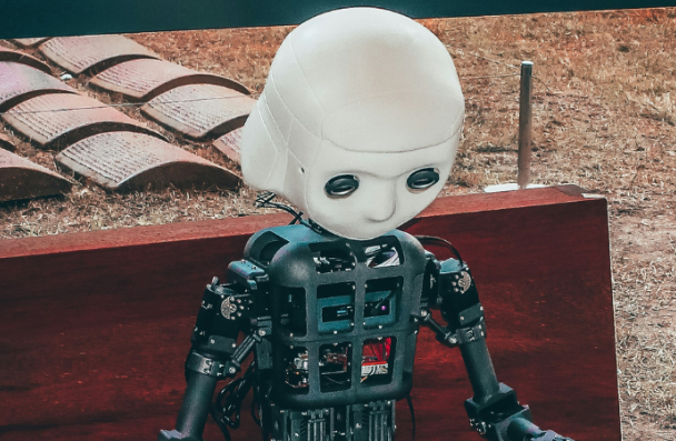 A robot sitting on a bench