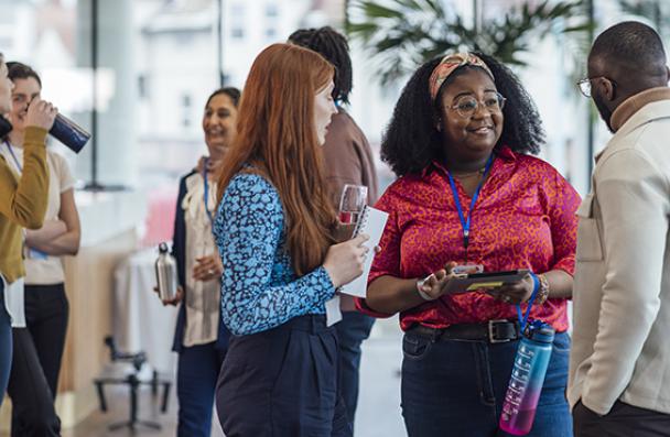 A group of three people talking in a circle