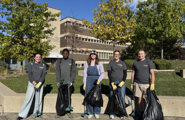 Group of students cleaning up litter on campus.