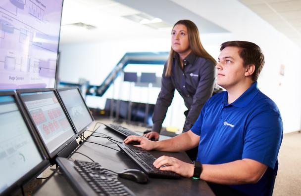 white male and female working on computer systems