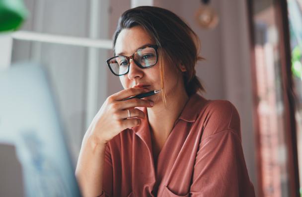 Young female browsing on a laptop.