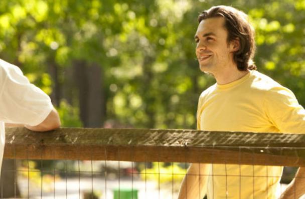 Neighbours talking over a fence