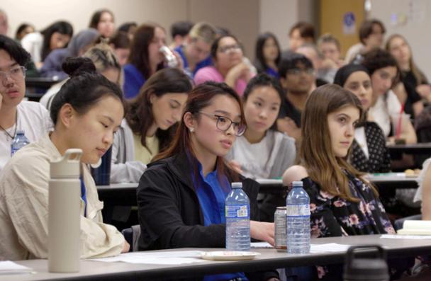 Students listening attentively in a lecture hall.