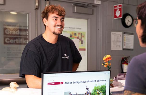 Student talking to a secretary.