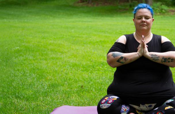woman sitting on yoga mat