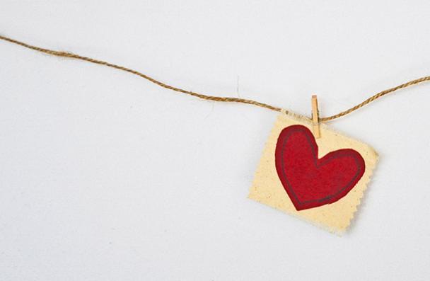 heart painted on paper hanging from string
