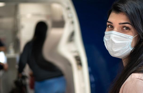 woman wearing mask entering the door