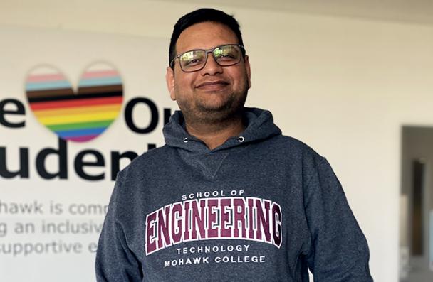 Hamza wearing a "School of Engineering Technology Mohawk College" sweater