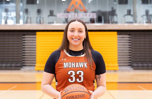 Maddie on the court with a basketball.