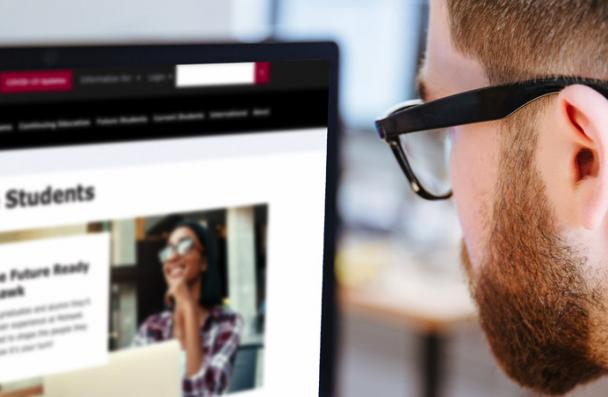 Student looking a blurred photo of the mohawk website