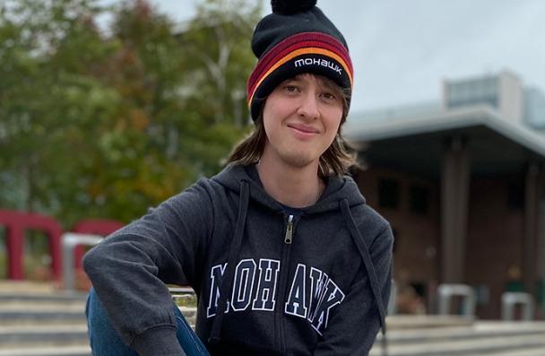 Oliver sitting on the steps at Fennell Campus