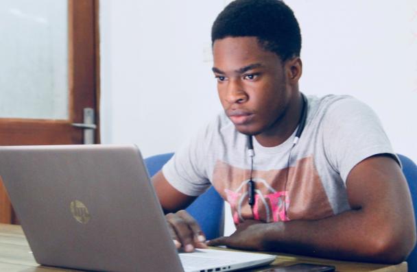 young black man working on laptop