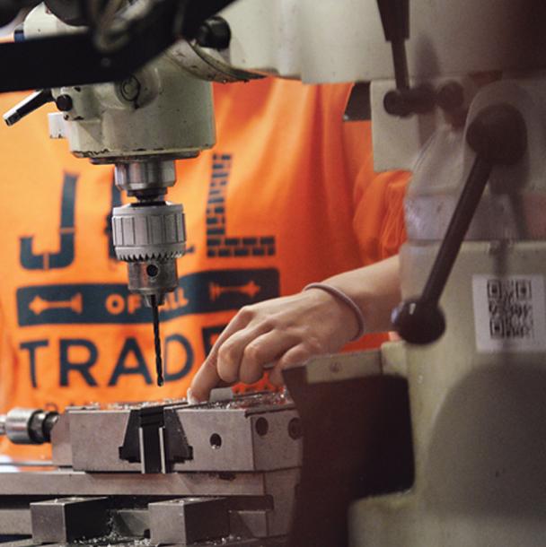A student cutting a pipe.