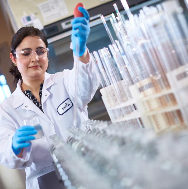 Scientist examining vials