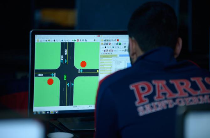 Transportation Engineering Technology student viewing traffic management software on a computer.