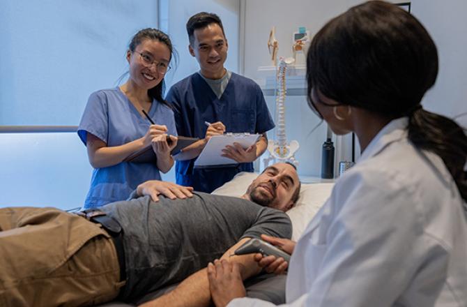 Medical students gathered around a patient getting his vitals checked.