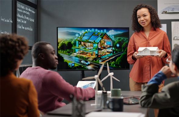 Young woman in meeting with green energy display models