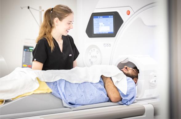 a nurse assisting a patient while in an MRI
