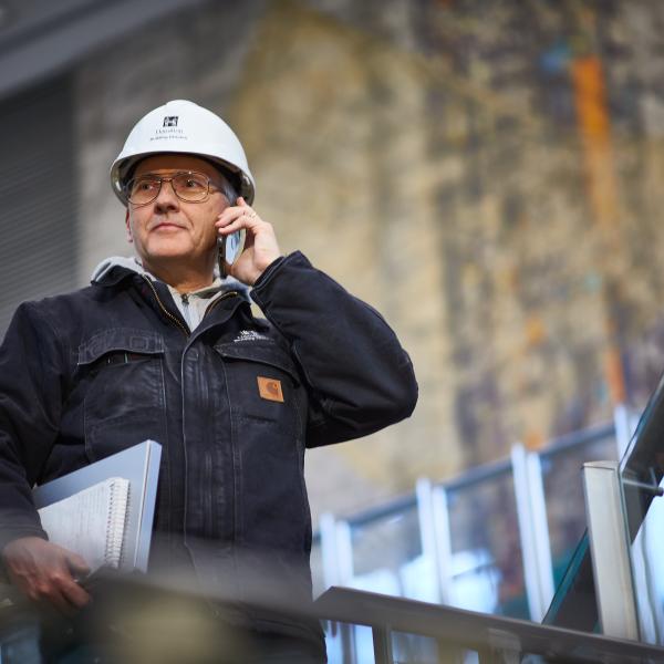 Man looks in the distance while taking a phone call.