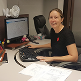 Emma working at her desk
