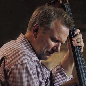 Pat Collins playing upright bass on stage